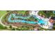 A winding lazy river offers residents a relaxing experience amid lush tropical surroundings at 7622 Oakmoss Loop, Davenport, FL 33837
