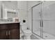 Bathroom featuring a white toilet, granite countertop vanity and a glass-enclosed shower at 7622 Oakmoss Loop, Davenport, FL 33837