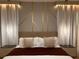 Bedroom with a stylish decorative wall, pendant lighting and a well made king bed at 7622 Oakmoss Loop, Davenport, FL 33837
