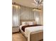 Bedroom with stylish lighting, decorative wall, sheer curtains and a well made king bed at 7622 Oakmoss Loop, Davenport, FL 33837