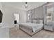 Bedroom with carpet, stylish lighting fixture, decorative wall and king bed at 7622 Oakmoss Loop, Davenport, FL 33837