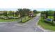 Well-maintained community entrance with signage, landscaping, security features, and gated access at 7622 Oakmoss Loop, Davenport, FL 33837