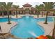 Large community pool with a waterslide, palm trees, and a spacious sunbathing area at 7622 Oakmoss Loop, Davenport, FL 33837