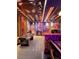 This expansive game room features a ceiling mural, air hockey, and a custom themed bar, providing ample entertainment options at 7622 Oakmoss Loop, Davenport, FL 33837