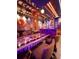 Custom-themed game room with bar area and stools at 7622 Oakmoss Loop, Davenport, FL 33837