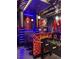 The game room's bar area includes custom Spider-Personal theming, seating, and arcade games, perfect for entertaining guests at 7622 Oakmoss Loop, Davenport, FL 33837