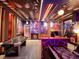 The game room features multiple game tables, custom lighting, and unique decorations creating a vibrant and entertaining space at 7622 Oakmoss Loop, Davenport, FL 33837