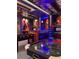 The game room features custom lighting, arcade games, a foosball table, and air hockey for ultimate entertainment at 7622 Oakmoss Loop, Davenport, FL 33837
