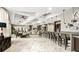 Modern indoor lounge featuring a bar area, stylish decor, comfortable seating and coffered ceilings at 7622 Oakmoss Loop, Davenport, FL 33837