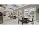 Elegant indoor lounge with tables, chairs, recessed lighting, and access to the community pool at 7622 Oakmoss Loop, Davenport, FL 33837