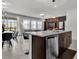 Kitchen island with granite countertops, stainless steel appliances and breakfast bar seating at 7622 Oakmoss Loop, Davenport, FL 33837