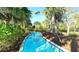 Scenic lazy river winding through lush tropical foliage, offering a serene and relaxing experience at 7622 Oakmoss Loop, Davenport, FL 33837