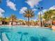 Lagoon style pool with a water slide and lounge chairs under gazebos at 7622 Oakmoss Loop, Davenport, FL 33837