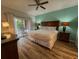 Stylish bedroom with a sliding glass door leading to a private balcony and an ensuite bathroom at 7650 Whisper Way # 102, Reunion, FL 34747