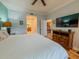 Bright bedroom with wood floors and an ensuite bathroom featuring a double vanity and walk-in shower at 7650 Whisper Way # 102, Reunion, FL 34747