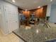 Modern kitchen features stainless steel appliances, granite countertops, and a breakfast bar at 7650 Whisper Way # 102, Reunion, FL 34747