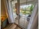 This patio features sliding glass doors, wood floors, and outdoor seating overlooking the yard at 7650 Whisper Way # 102, Reunion, FL 34747