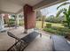The outdoor patio has brick pillars and multiple seating areas with a view of the lawn at 7650 Whisper Way # 102, Reunion, FL 34747