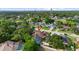 Aerial view of the home with a screened-in pool in a tree-filled neighborhood at 7846 Snowberry Cir, Orlando, FL 32819