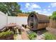 Backyard featuring a unique barrel sauna, picnic table, and well-maintained landscaping at 7846 Snowberry Cir, Orlando, FL 32819