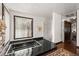 Large tiled bathtub next to window and stand up shower, in a well lit bathroom at 7846 Snowberry Cir, Orlando, FL 32819