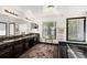 Large bathroom features double sink vanity, plush rug, and a separate bathtub at 7846 Snowberry Cir, Orlando, FL 32819
