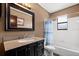 Bathroom with granite vanity, large mirror and tiled shower and tub at 7846 Snowberry Cir, Orlando, FL 32819