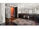 Large bathroom features a double sink vanity with dark wood cabinetry and a plush rug at 7846 Snowberry Cir, Orlando, FL 32819