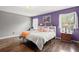 Bright bedroom features hardwood flooring, large window and stylish decor at 7846 Snowberry Cir, Orlando, FL 32819