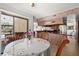Bright breakfast nook with sliding doors to the pool area and adjacent to the kitchen with tiled flooring at 7846 Snowberry Cir, Orlando, FL 32819