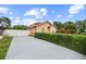 View of the house exterior featuring a driveway and manicured landscaping at 7846 Snowberry Cir, Orlando, FL 32819