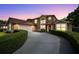 Charming two-story home with an attached garage and a neatly landscaped circular driveway at 7846 Snowberry Cir, Orlando, FL 32819