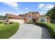 Charming two-story home with an attached garage and a well-maintained lawn at 7846 Snowberry Cir, Orlando, FL 32819