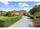 Stunning two-story home with a circular window, manicured hedges, and a long driveway at 7846 Snowberry Cir, Orlando, FL 32819
