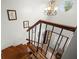 Bright foyer features hardwood steps, wrought iron railing and view of the front door at 7846 Snowberry Cir, Orlando, FL 32819