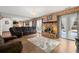 Cozy living room featuring a brick fireplace, plush seating, and sliding glass doors to the backyard at 7846 Snowberry Cir, Orlando, FL 32819