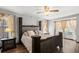 Well-lit bedroom featuring a king-sized bed, neutral decor, and decorative curtains at 7846 Snowberry Cir, Orlando, FL 32819