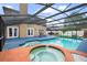 Enjoy the outdoors with a large screened-in pool and spa with a covered lanai at 7846 Snowberry Cir, Orlando, FL 32819
