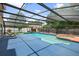 Inviting screened-in pool area with hot tub, lounge chairs, and a view of the surrounding greenery at 7846 Snowberry Cir, Orlando, FL 32819
