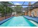 Screened-in pool area with lounge chairs, hot tub, and lush greenery, offering a serene backyard oasis at 7846 Snowberry Cir, Orlando, FL 32819
