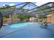 Spacious screened-in pool with hot tub, lounge chairs, and storage shed, perfect for outdoor entertaining at 7846 Snowberry Cir, Orlando, FL 32819