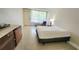 Bedroom featuring a bed, dresser, and window view of the outside at 7900 S Orange Blossom Trl # 2102, Orlando, FL 32809