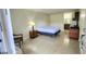 Open bedroom layout with vanity, drawers and bathroom in background at 7900 S Orange Blossom Trl # 2102, Orlando, FL 32809