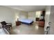 Open bedroom layout with vanity, drawers and bathroom in background at 7900 S Orange Blossom Trl # 2102, Orlando, FL 32809