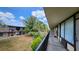 View of the grounds from a balcony with mature palm trees and building's facade at 7900 S Orange Blossom Trl # 2102, Orlando, FL 32809