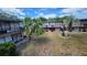 Exterior view of the units, showing balconies and mature landscaping in the courtyard at 7900 S Orange Blossom Trl # 2102, Orlando, FL 32809