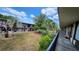 View of the grounds from a balcony with mature palm trees and building's facade at 7900 S Orange Blossom Trl # 2102, Orlando, FL 32809