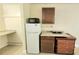 The kitchenette area is equipped with a refrigerator and microwave at 7900 S Orange Blossom Trl # 2102, Orlando, FL 32809