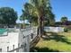 Pool area with lush landscaping, iron and white picket fencing, and lounge chairs by the pool at 7900 S Orange Blossom Trl # 2102, Orlando, FL 32809
