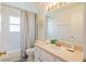 Well-lit bathroom with a shower-tub combination, a neutral-toned vanity, and a large mirror at 8491 Oasis Key Cv, Kissimmee, FL 34747
